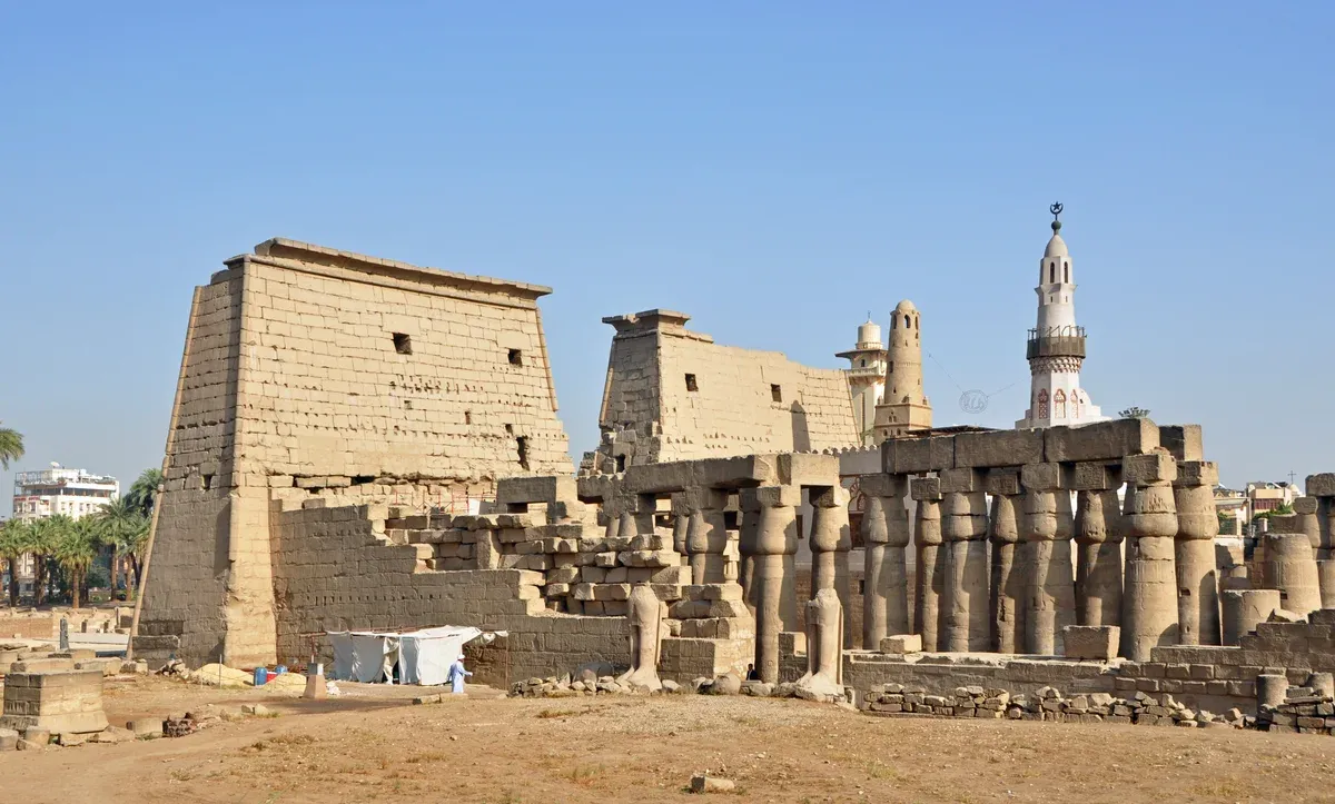 The pylon and colonnade of Luxor Temple under a clear sky, seen on a Valley of the Kings tour
